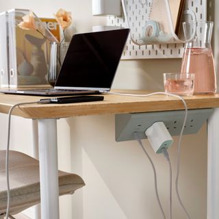 IKEA's SKOTAT extension cord used on the bottom of a home office desk