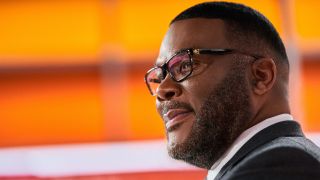 Tyler Perry smiling during a newscast in Don't Look Up.