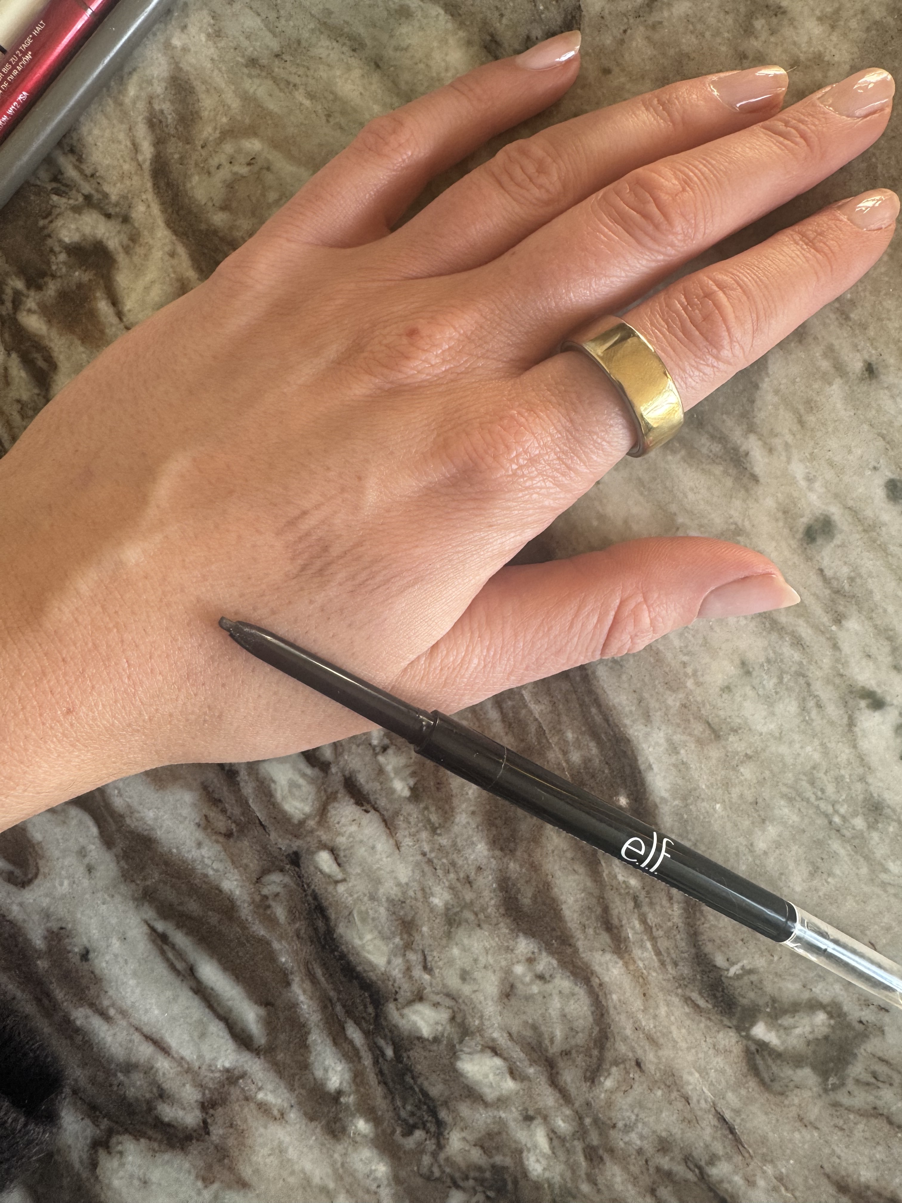 Beauty editor Eleanor swatching the Elf brow pencil on her hand