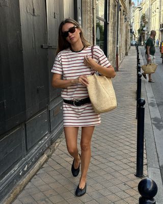 Woman in striped dress and ballet flats.