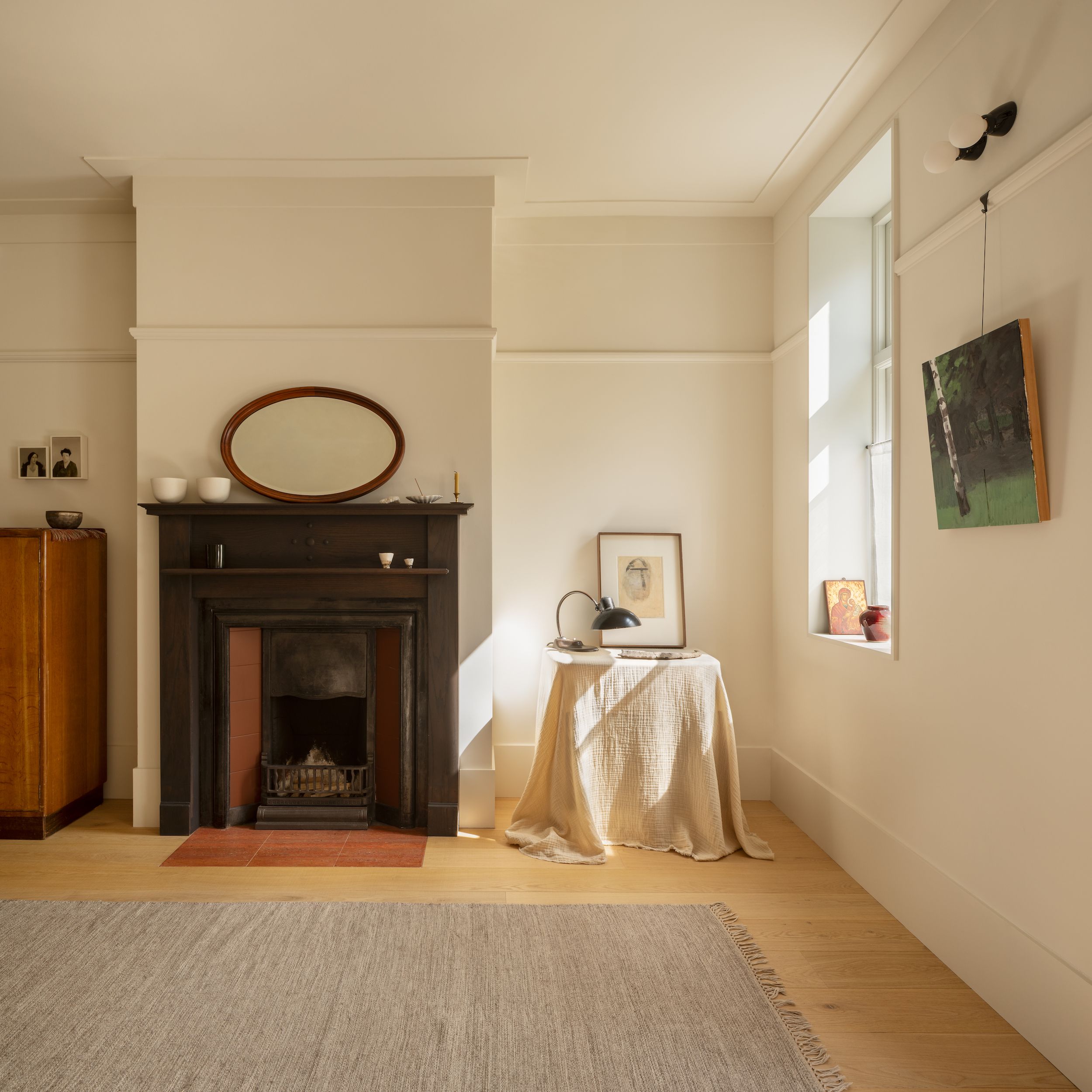 Details of a sun-filled London home with wooden surfaces, period details, including a fireplace, and plenty of collectibles.
