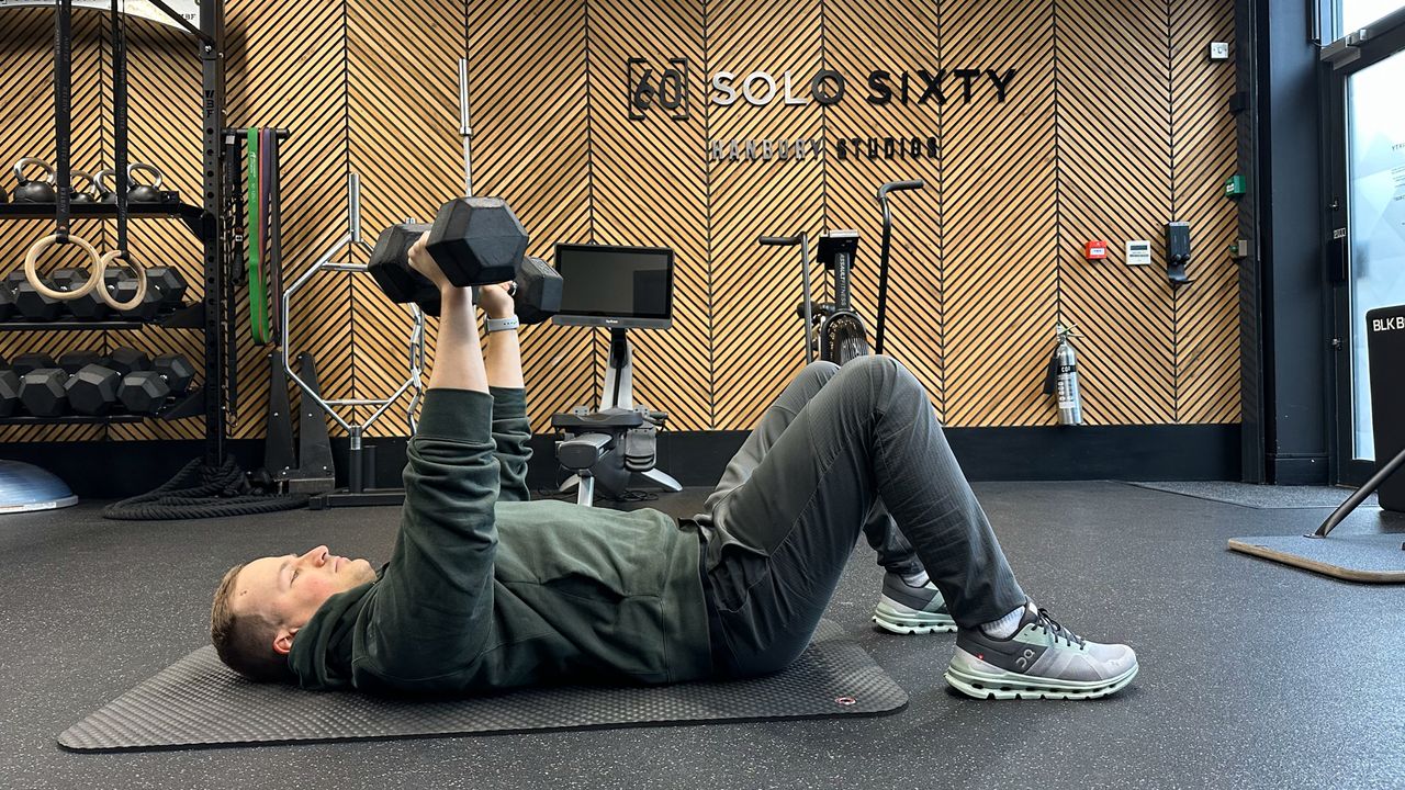 Ollie Thompson performing a dumbbell floor press