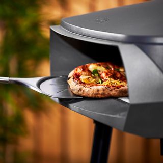 Witt pizza oven with pizza and pizza peel