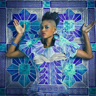 'Mame' from the series 'Studio of Vanities' by Omar Victor Diop,2013 - a woman wearing panited clothes to match the background of blue patterned tiles