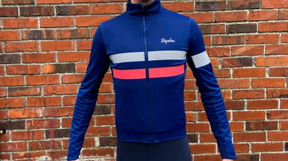 Image shows a rider wearing the Rapha Men's Brevet Insulated Long Sleeve Gore-Tex Infinium Jersey