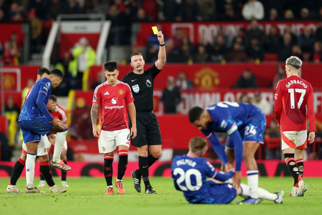 MANCHESTER, ENGLAND - NOVEMBER 03: Lisandro Martinez of Manchester United is shown a yellow card from referee Robert Jones after a foul on Cole Palmer of Chelsea during the Premier League match between Manchester United FC and Chelsea FC at Old Trafford on November 03, 2024 in Manchester, England. (Photo by Carl Recine/Getty Images)