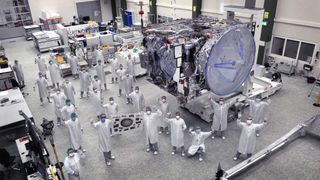 Engineers at Airbus Defence and Space in Friedrichshafen, Germany, celebrate as the completely assembled Jupiter-exploring spacecraft JUICE is to leave the facility to commence a pre-launch test campaign.