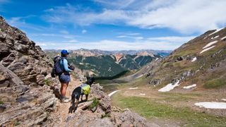 A woman and her dog hiking in the San Juan mountains of Colorado
