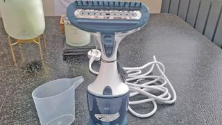 Clothes steamer on table