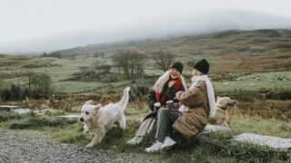 Two woman with their dogs outside