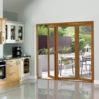 bifold wooden door on white wall and white flooring