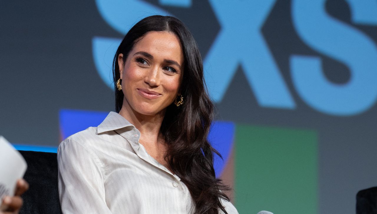 Meghan Markle sits onstage at South by Southwest wearing a button down shirt