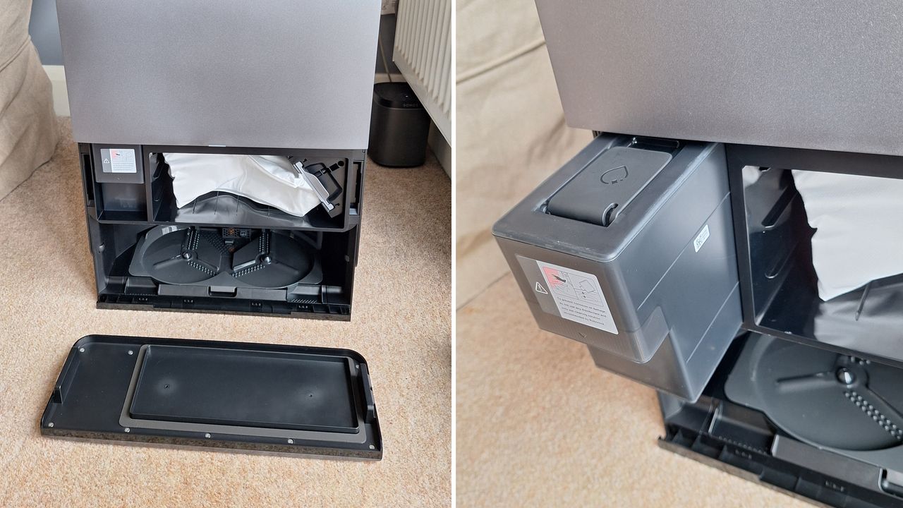 Roborock Saros 20 robot vacuum dock with front cover removed to show dust bag and floor cleaner dispenser