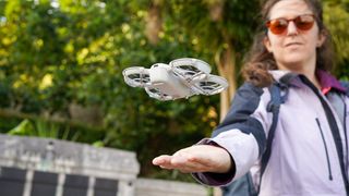 DJI Neo landing on a person's palm