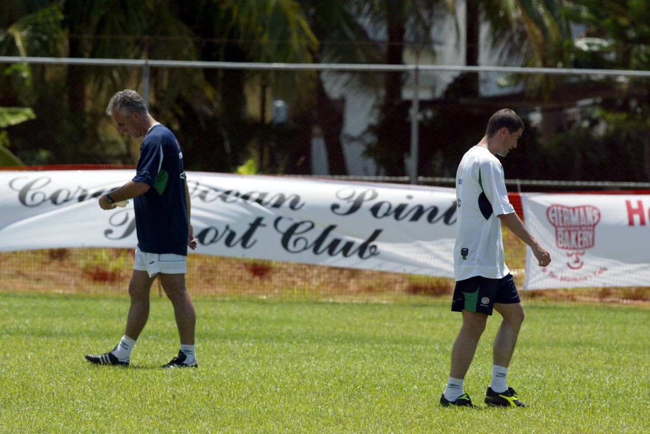 Republic of Ireland manager Mick McCarthy and player Roy Keane walk past each other during a 2002 World Cup training session