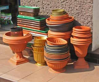 stacks of old plastic plant pots in sun