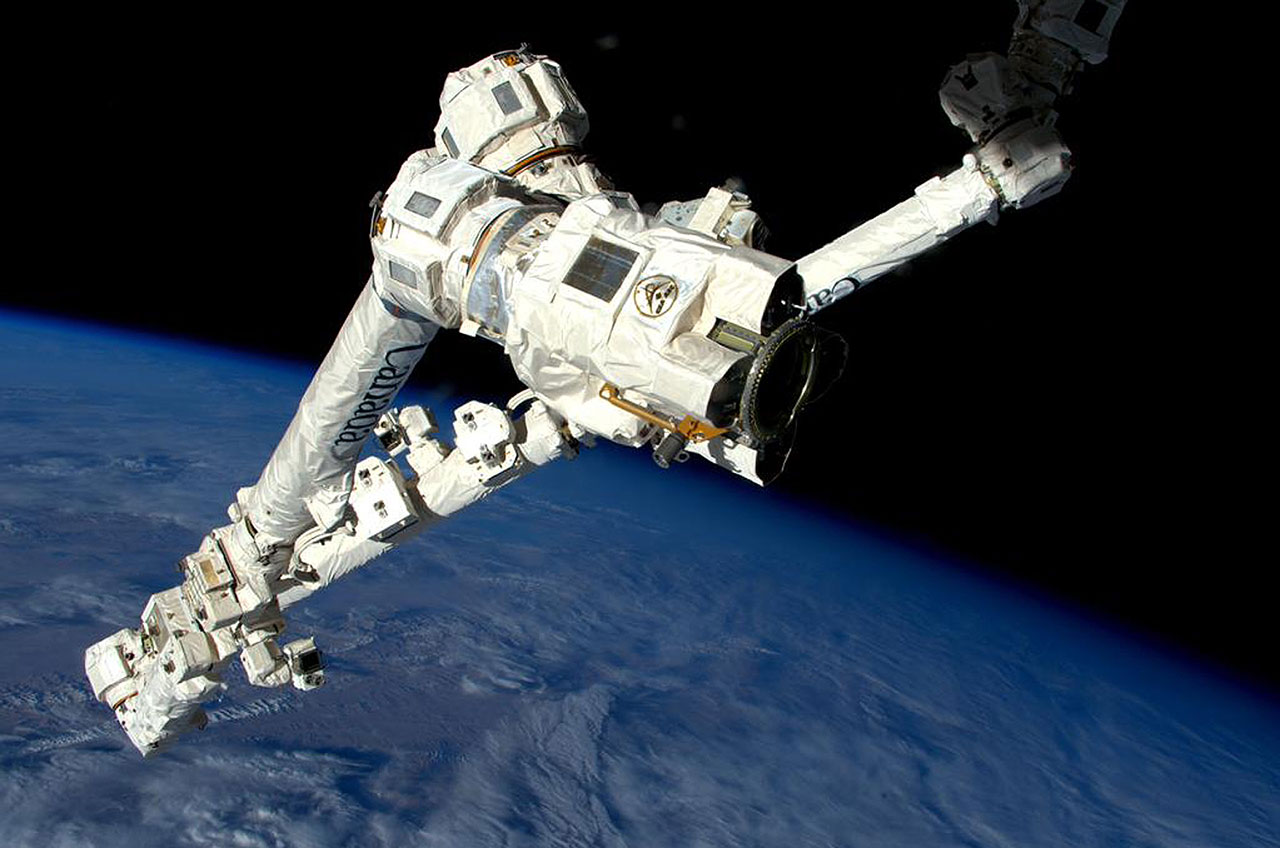 astronauts-give-a-hand-to-robotic-arm-on-spacewalk-outside-station