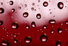 Soft drinks brand Dr. Pepper logo is seen reflected in water drops