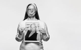 Black and white photo of acid attack survivor Patricia Lefranc, holding a photo of her taken before she was attacked, photographed by Rankin for the Tear Couture Look Book campaign