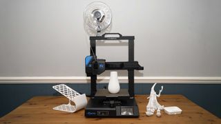 Mingda Magician X2 printing a white vase, surrounded by a 3D printed phone holder and model