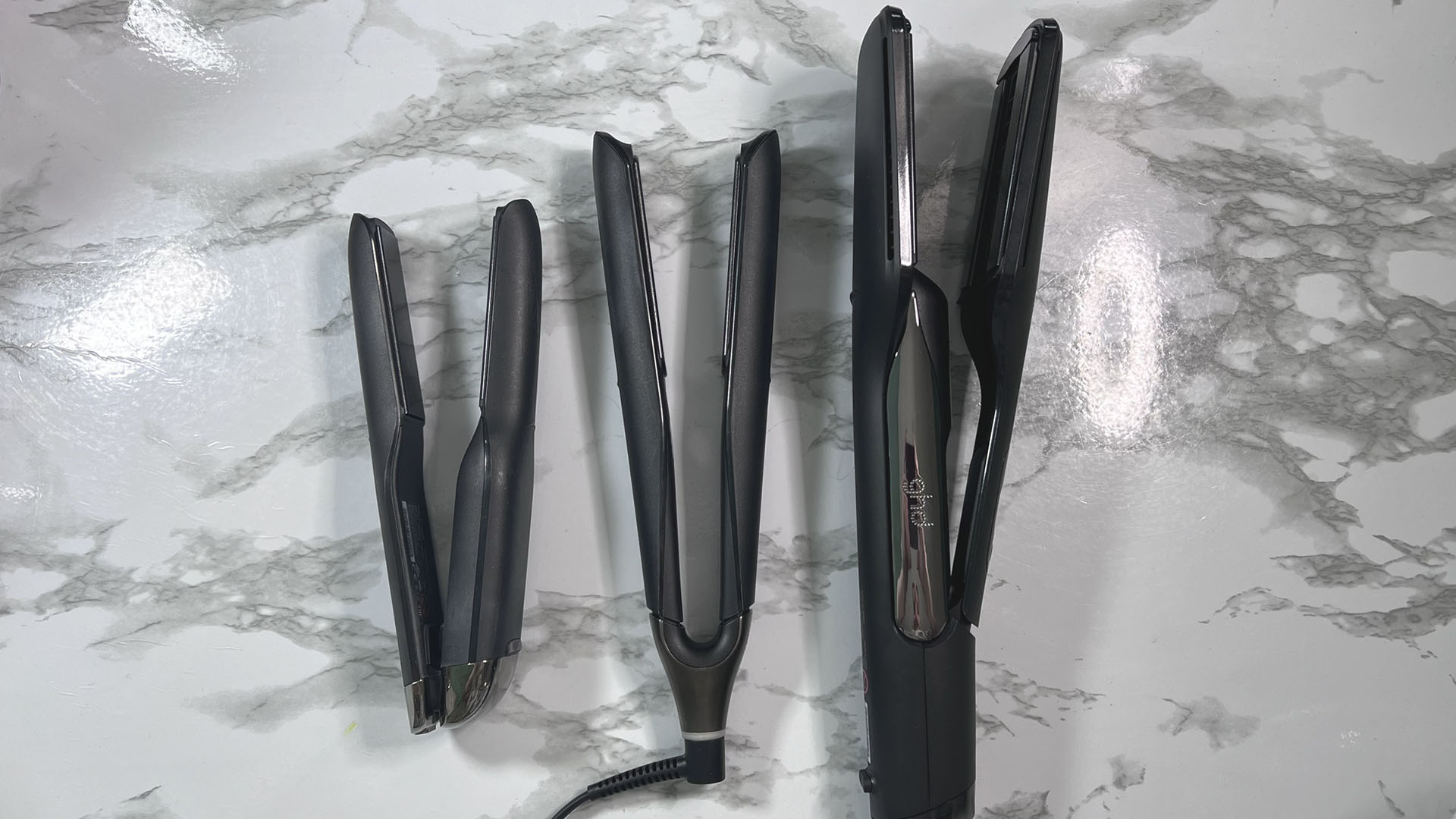 GHD Duet Style hair styler with other GHD stylers to show how the sizes compare