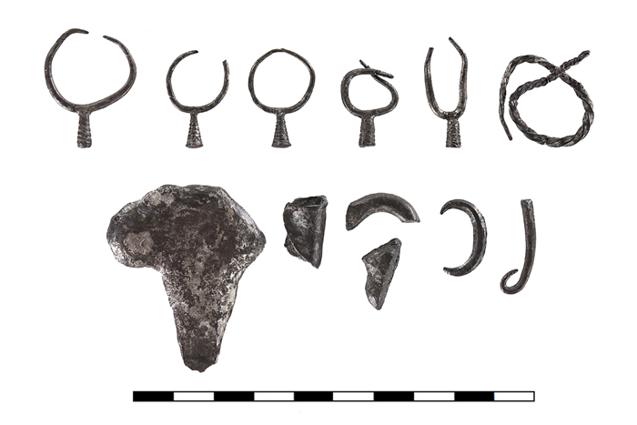 After conservation work was done by Mimi Lavi, of the Hebrew University of Jerusalem's Institute of Archaeology, the researchers found the treasure consisted of five earrings (top) and an enigmatic object (top right) that appears twisted like a knot.