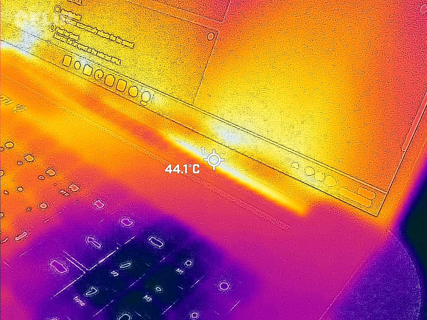 Razer Blade 18 (2025) gaming laptop viewed with a FLIR thermal camera showing hot and cool spots