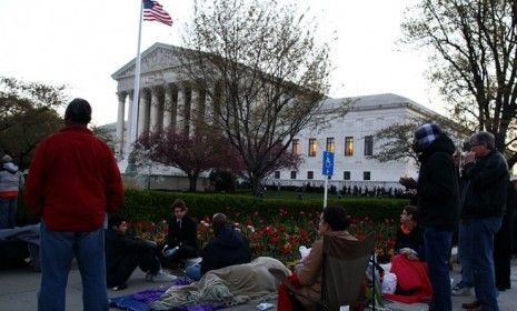 People wait in line in front of the Supreme Court early Monday morning to hear arguments over the constitutionality of President Obama&amp;#039;s health care reform.