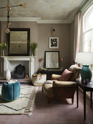 pink tiled living room with brown leather chair and kilim style rug