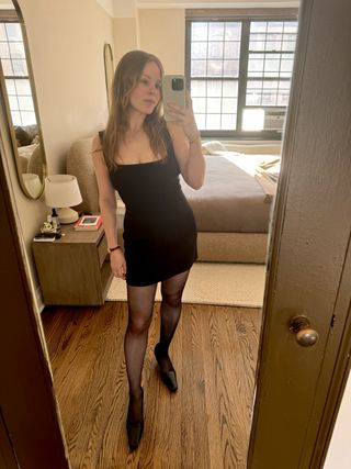 Nikki wears an LBD, tights, and pumps