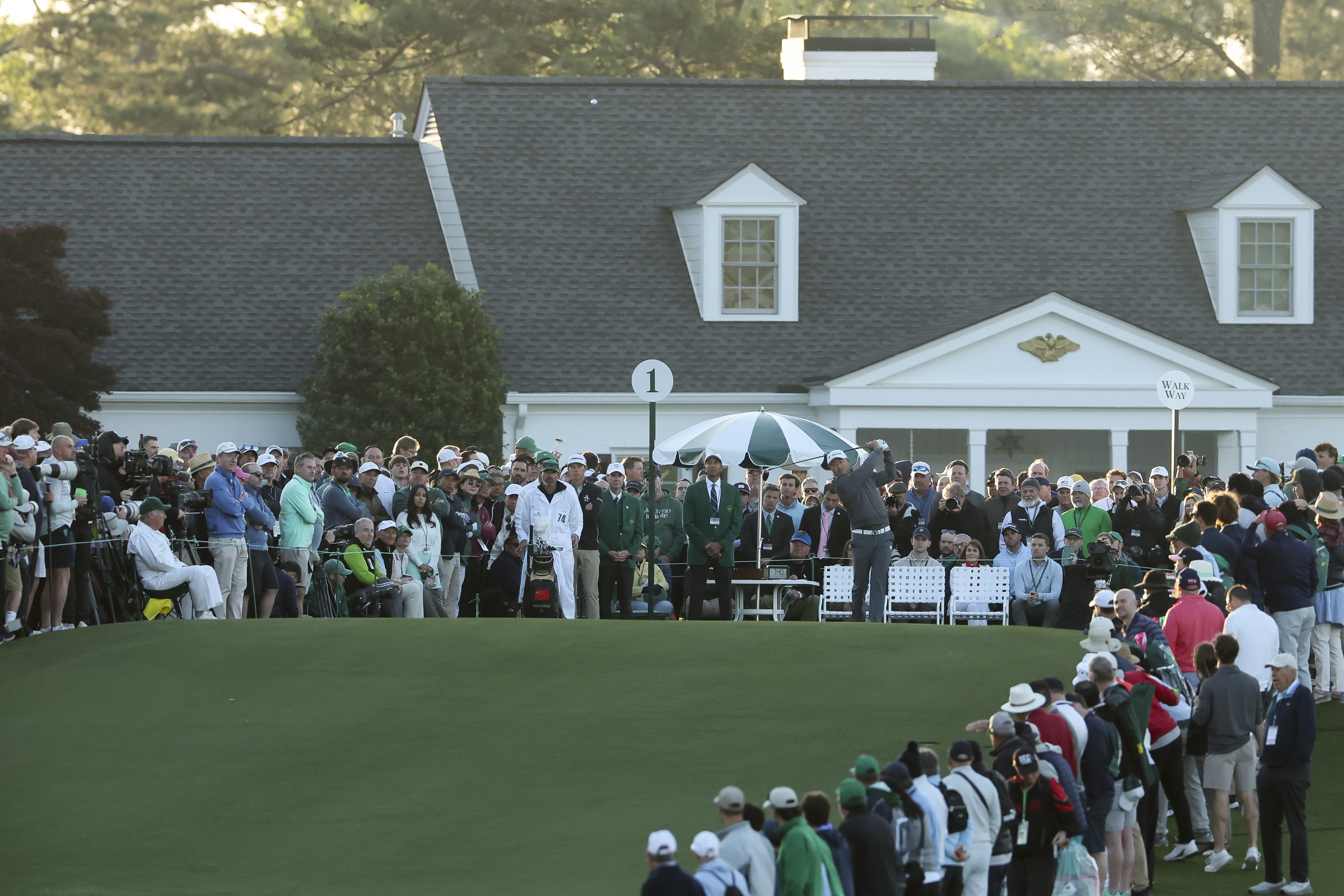 Haotong Li plays his shot from the first tee during the first round of the 2026 Masters Tournament at Augusta National Golf Club