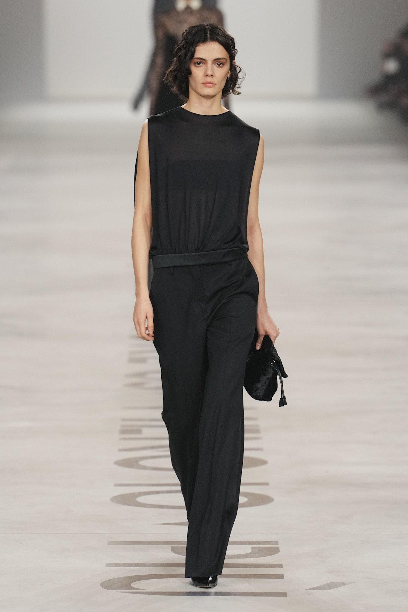 a model on the fendi runway wearing a matching black set