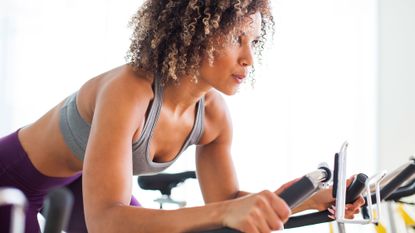 Woman enjoying the benefits of indoor cycling