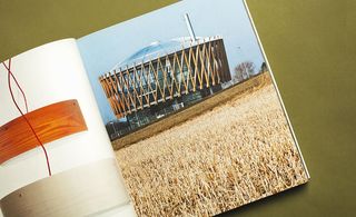 Power plant building near dried land on page of book