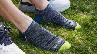 Man's feet wearing Darn Tough No Show Tab Ultra-Lightweight Running Socks