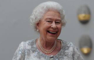 Queen Elizabeth II laughs as she attends a special 'Celebration of the Arts'