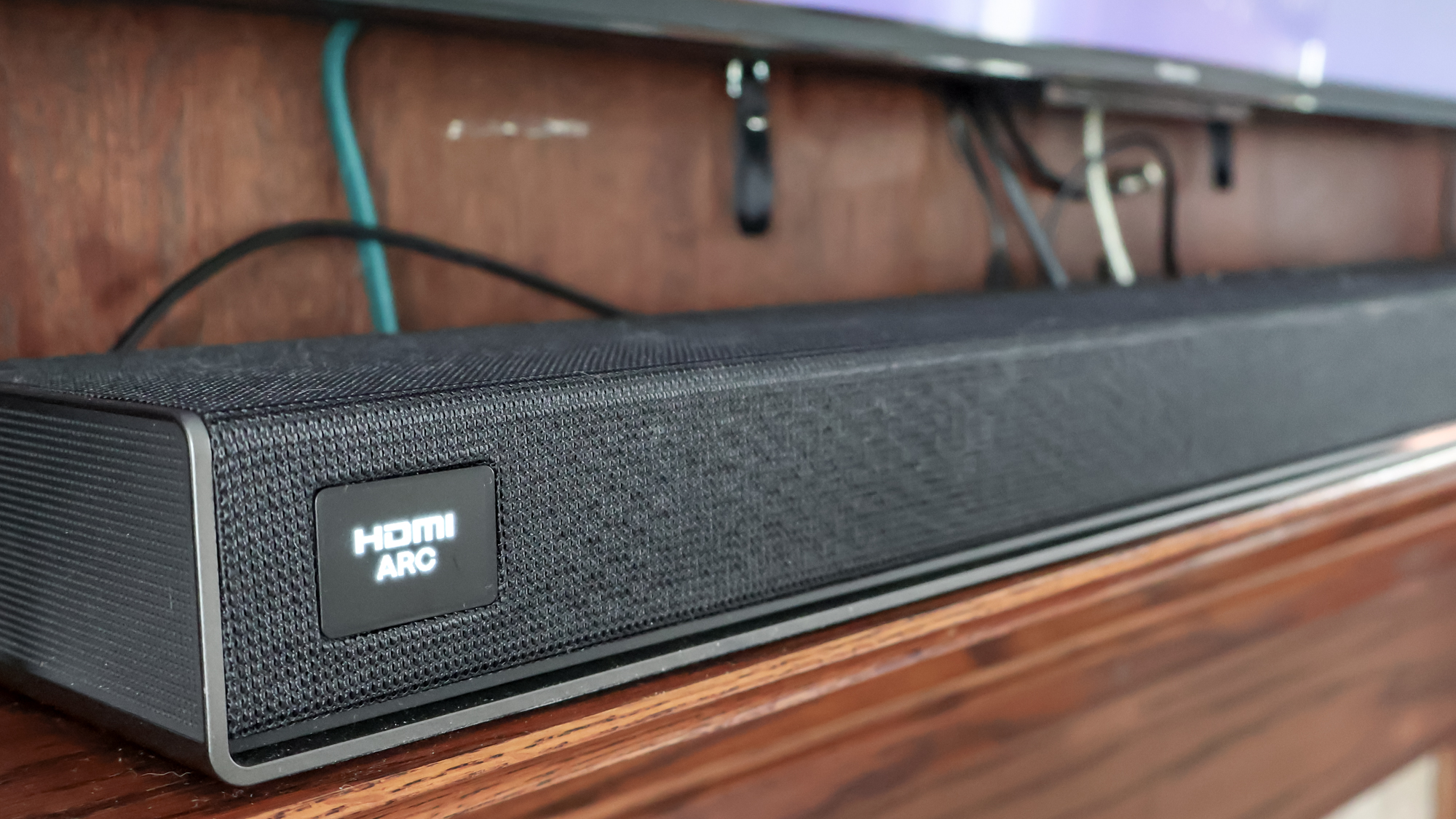 LG Sound Suite H7 Soundbar on a TV stand