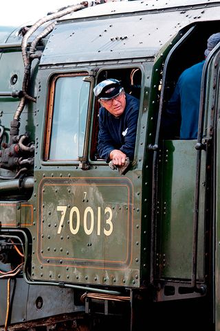 A driver on the footplate of Britannia class steam locomotive No. 70013, aka 'Oliver Cromwell'