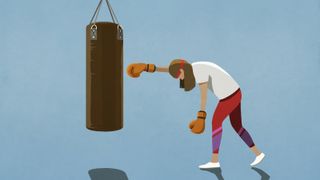 woman exhausted trying to punch a punching bag