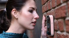 Woman speaking into SwannBuddy4K video doorbell