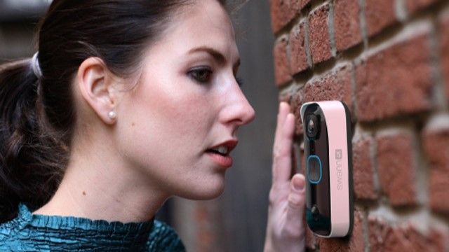 Woman speaking into SwannBuddy4K video doorbell