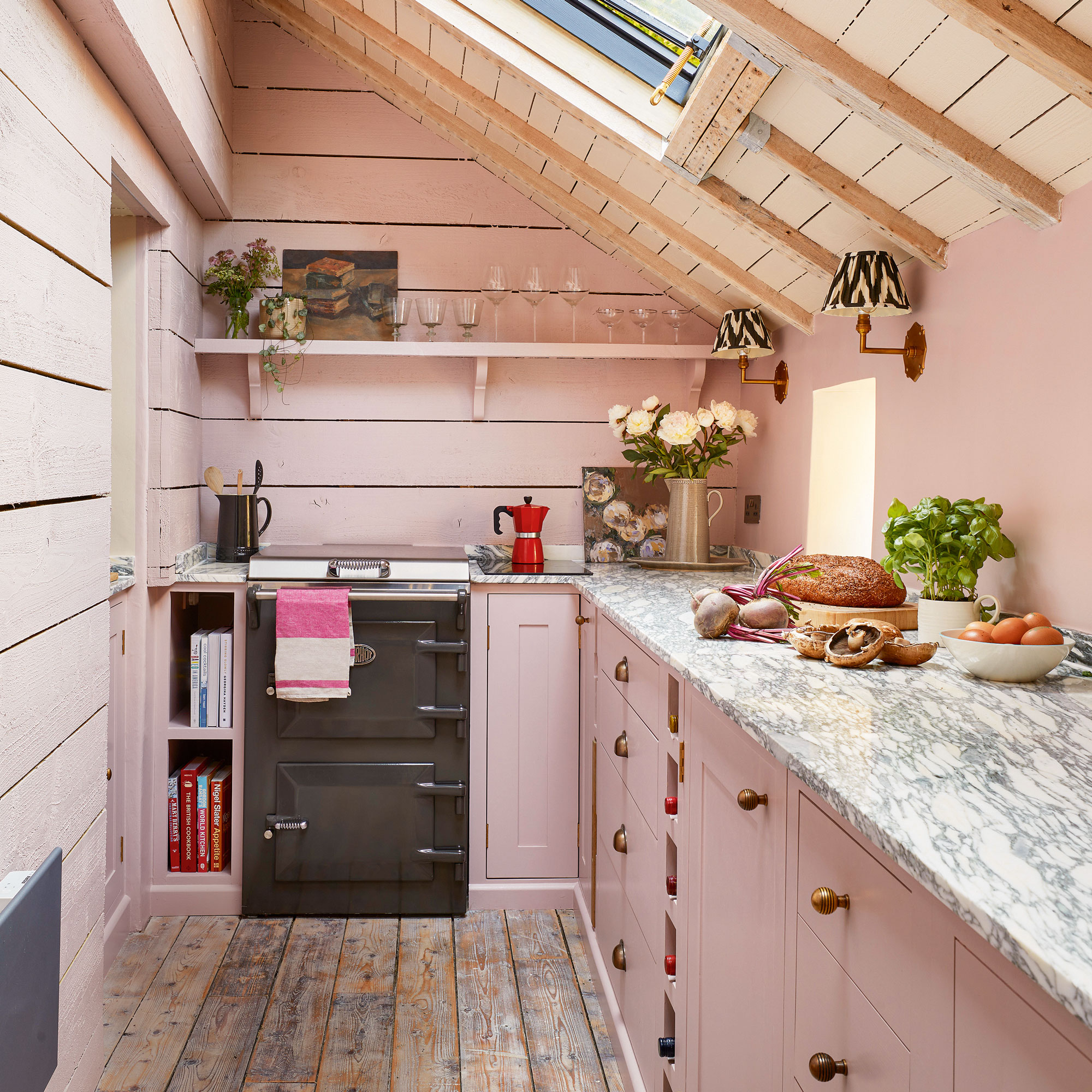 Pink kitchen with wood slats and a marble top