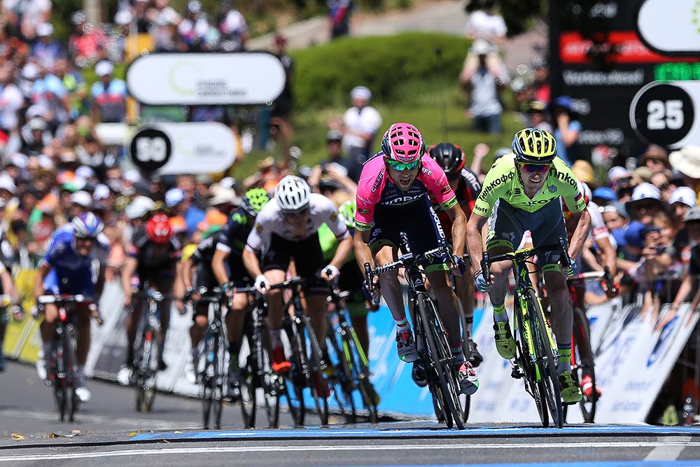 Jay McCarthy reaches for the stage 2 line ahead of Diego Ulissi.