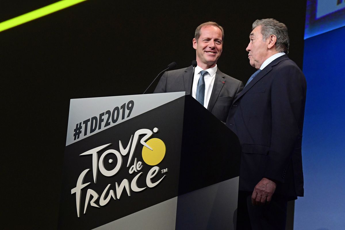 Christian Prudhomme on stage with Eddy Merckx, who is being celebrated with the Brussels Grand D&eacute;part