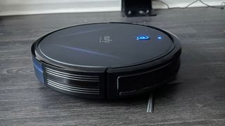 The side of the Eufy RoboVac G20 with a side brush visible