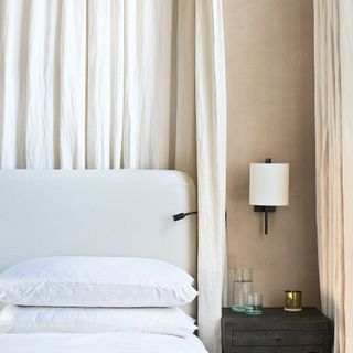 bedroom with white curtains and bedside lamp