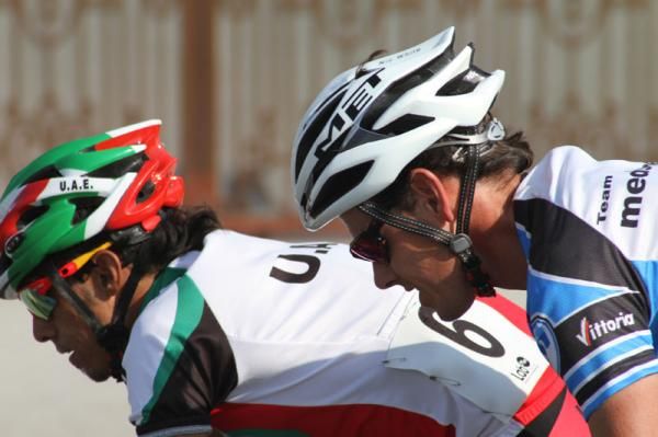 A Team Medscheme rider races alongside a rival from the UAE