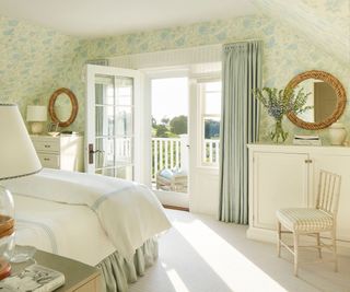bedroom with floral wallpaper and french doors open