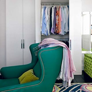 dressing room with green arm chair and wooden floor