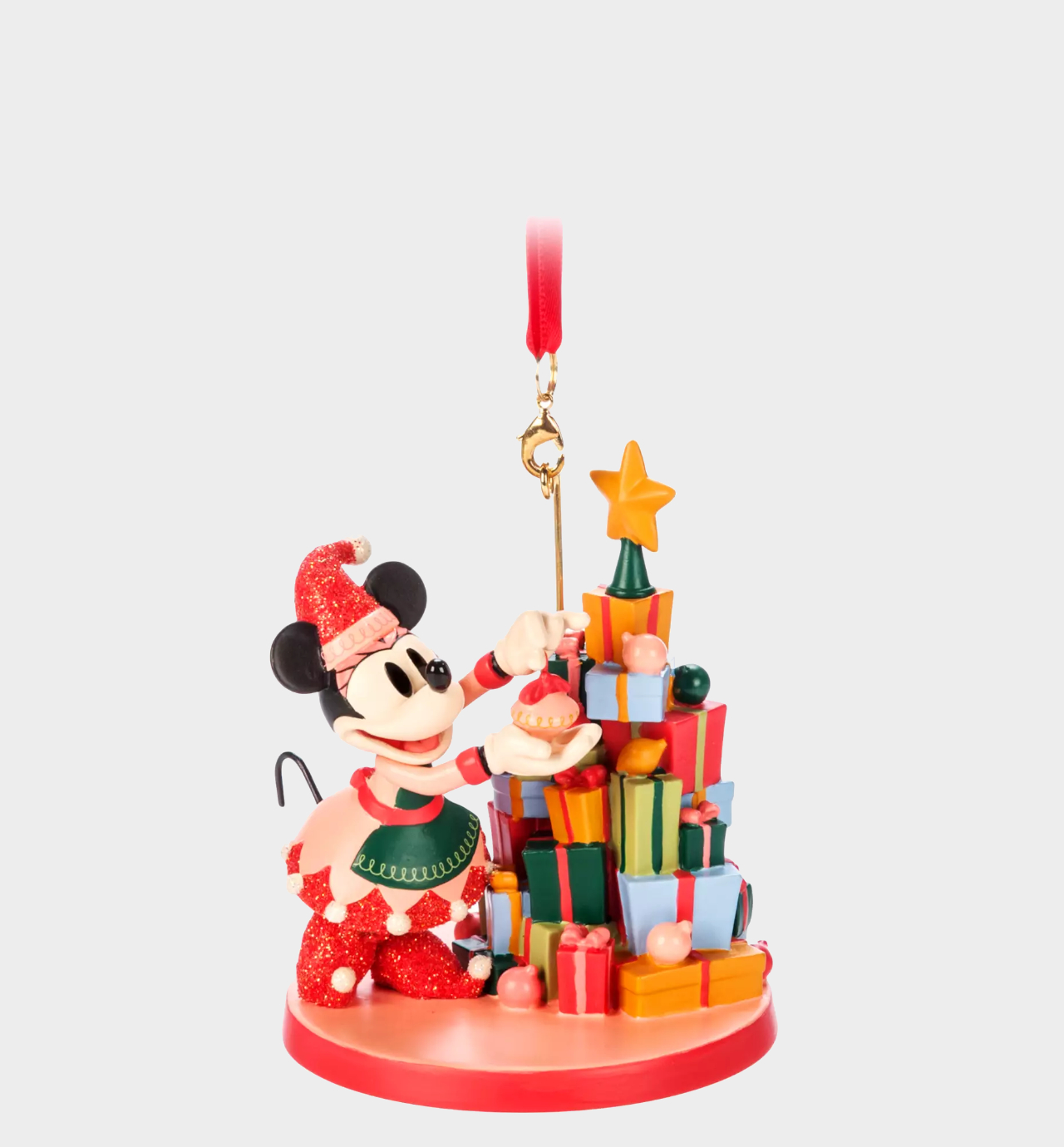 Disney ornament of Minnie Mouse hanging baubles from a tree made of presents